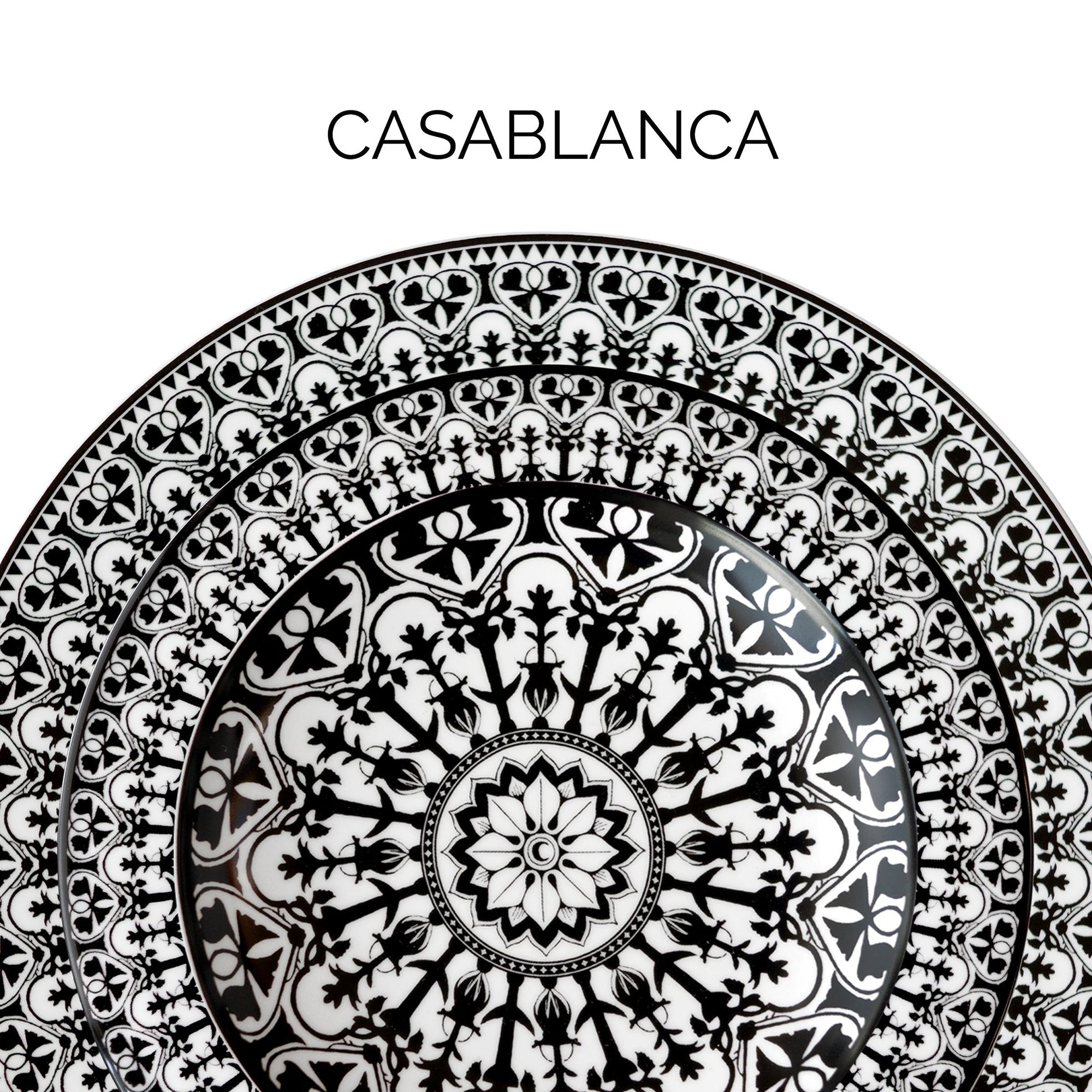 Close-up of a decorative plate with intricate black and white geometric patterns and floral motifs. The word "Casablanca" is written above the plate.