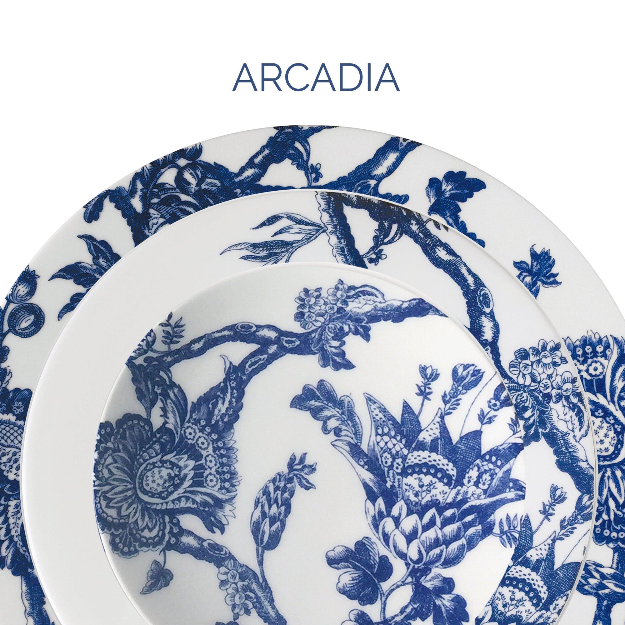 Close-up image of three white plates with blue floral and branch designs, arranged concentrically, labeled "Arcadia" at the top.