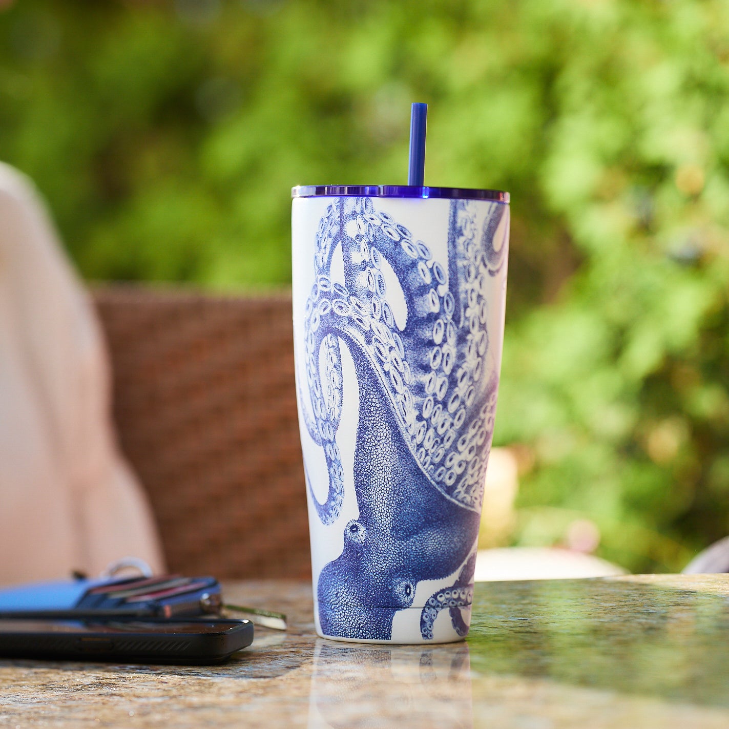 Lucy Stainless Steel Insulated Tumbler by Caskata, showcasing a blue octopus design, a black rim, and a coordinating blue straw.