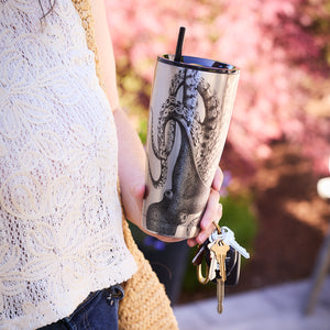 A person holding the elegant Lucy Chrome Stainless Steel Insulated Tumbler by Caskata and a set of keys embodies an ideal combination of functionality and oceanic allure.