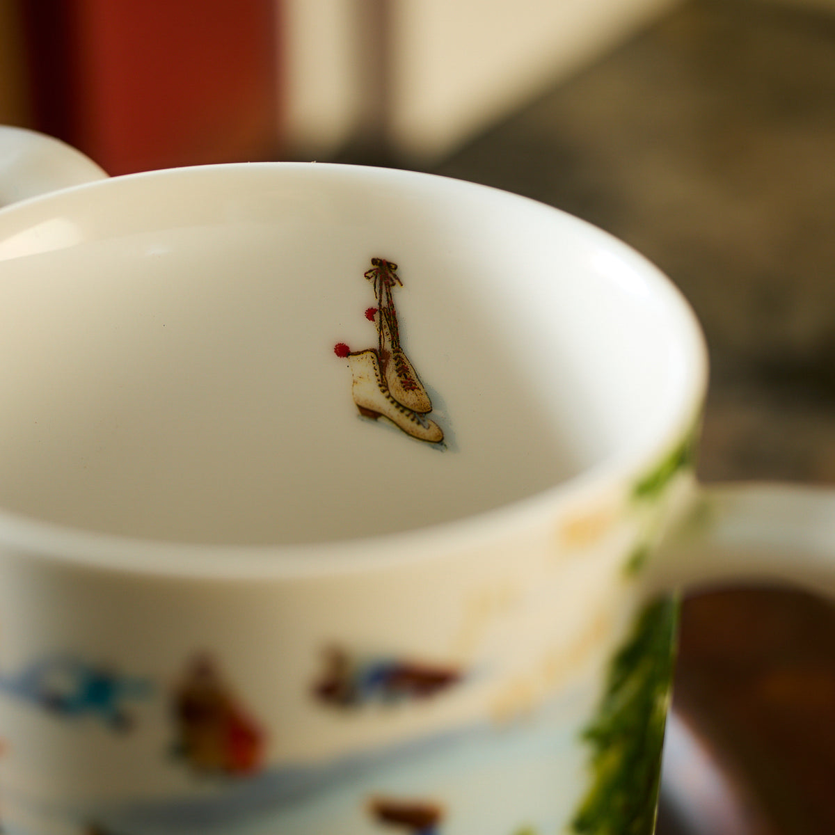 Inside one of the Caskata X Felix Doolittle Winter Wonderland mugs from the set, there is a small illustration of a stringed musical instrument at the bottom.