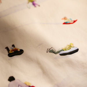 Close-up of the Caskata X Felix Doolittle Winter Wonderland kitchen towels, featuring small illustrations of people sledding and charming winter scenes, perfect for holiday gifts or crafting cozy cotton kitchen accents.