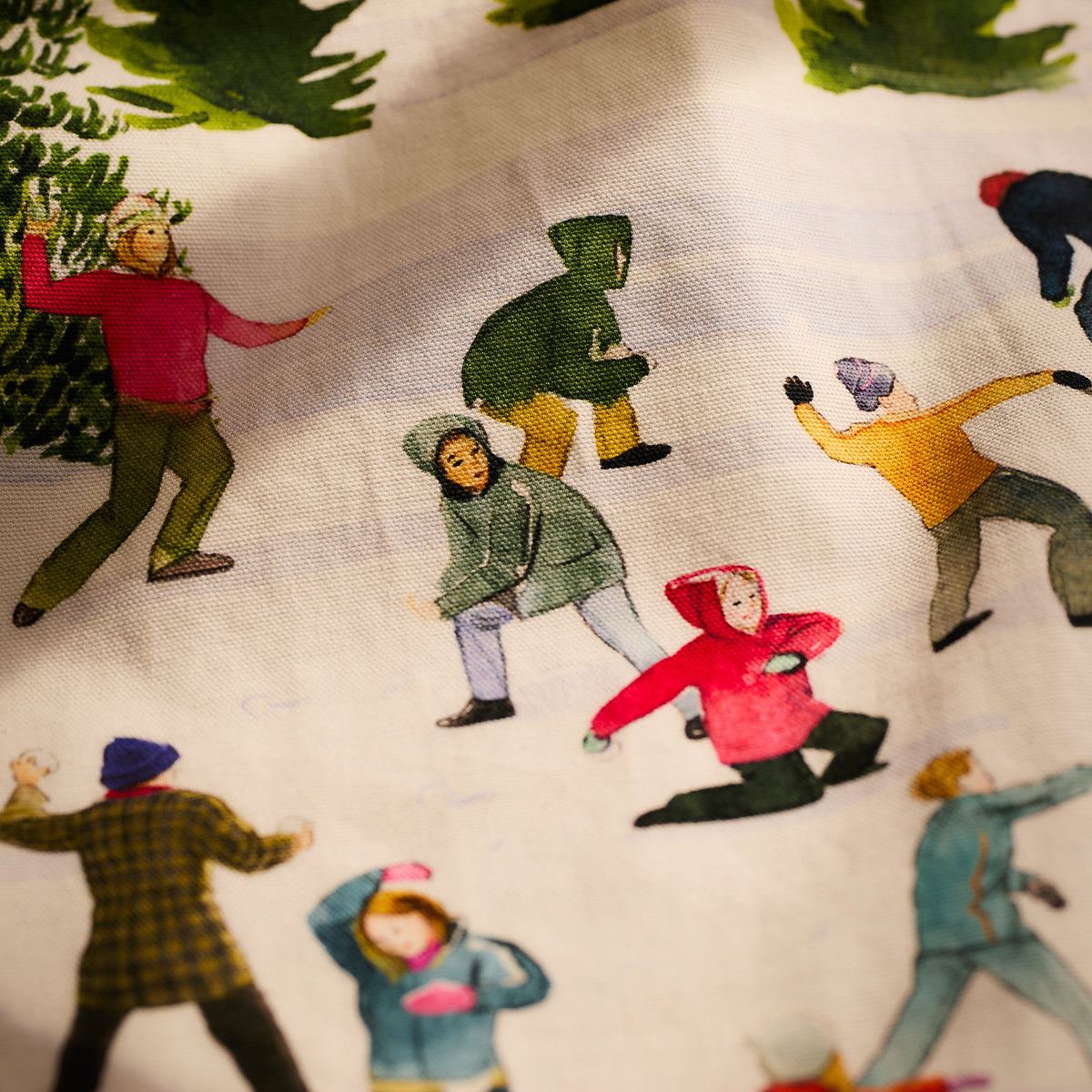 Illustration of people in vibrant winter attire enjoying a snowball fight amid trees. This dynamic scene, full of seasonal joy and color, is ideally suited for the Caskata X Felix Doolittle Snowball Fun Kitchen Towels, Set of 2. These cotton towels are perfect for adding warmth and cheer to your home during chilly days.