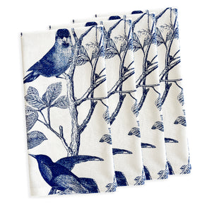 Explore the Blue Branches Luncheon Bundle by Caskata—a set of four folded fabric napkins featuring a blue and white bird-on-branches design. Ideal for simple gatherings or enhancing your spring table with elegance.