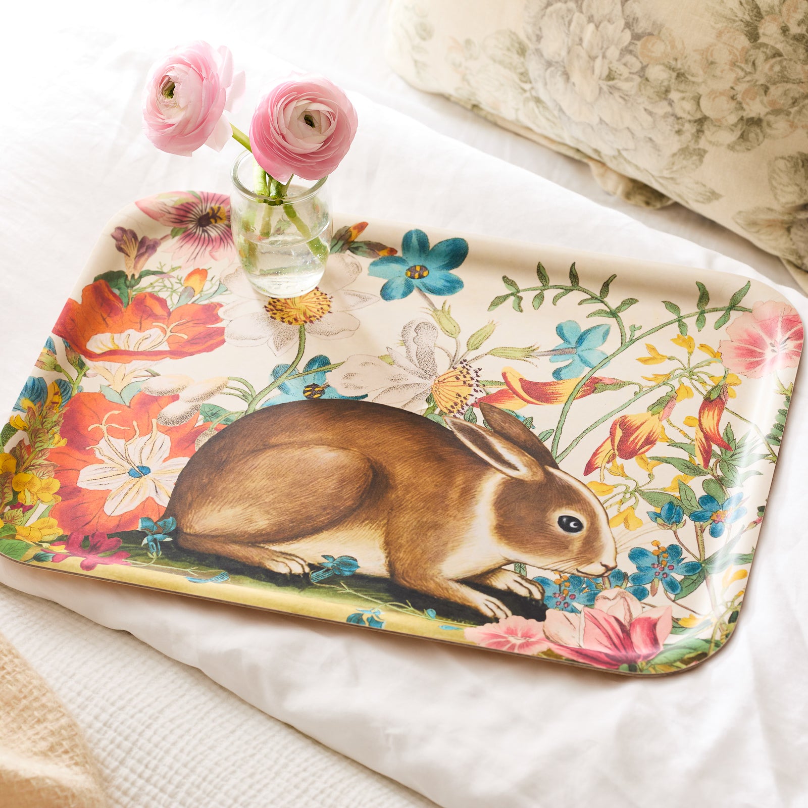 The Caskata Bunny Maximus Large Rectangular Birchwood Tray features a brown bunny nestled among colorful flowers and lush greenery.