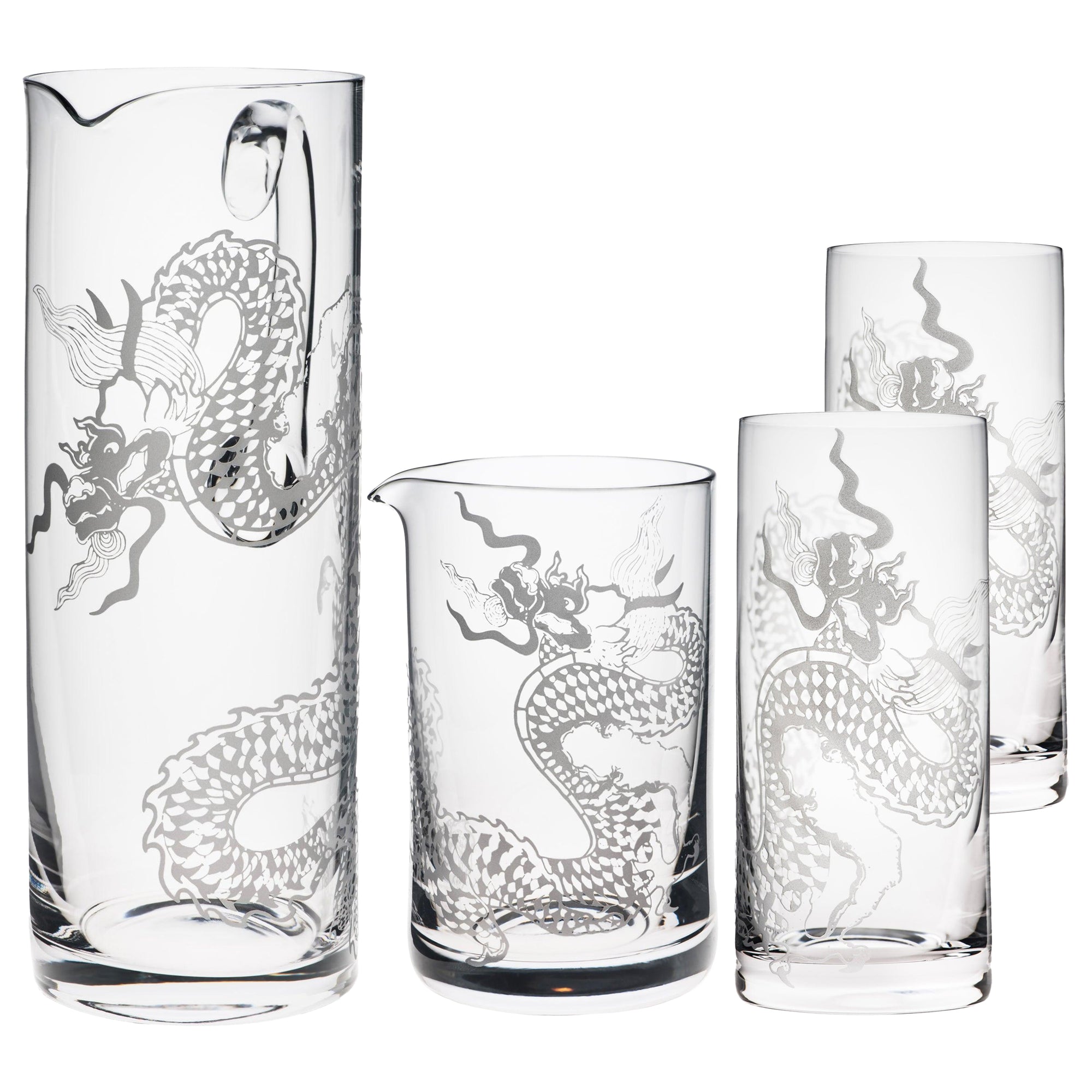 The Dragon Glassware Bundle by Caskata includes four lead-free crystal pieces: two intricately sand-etched dragon design pitchers and two tall glasses.