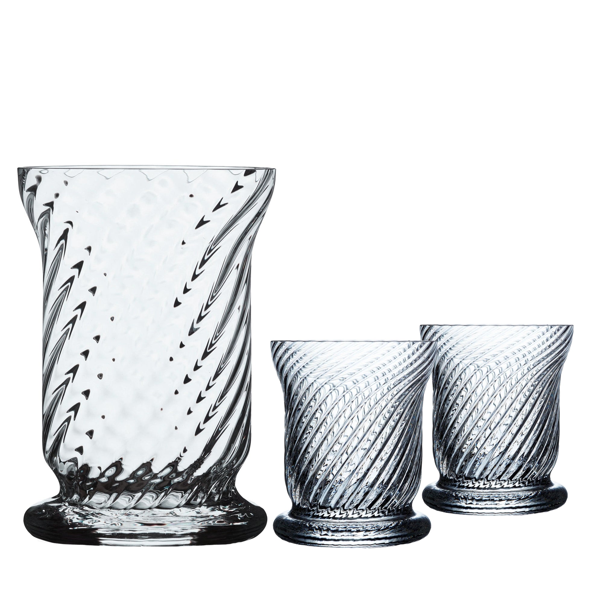 The Quinn Clear Candlelight Bundle by Caskata features a large and two smaller glass vases with spiral patterns, made from lead-free crystal, showcasing exquisite craftsmanship reminiscent of Czech Republic glassworks.