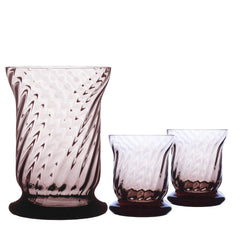 The Quinn Mocha Candlelight Bundle by Caskata features a set of three purple-tinted, mouth-blown glass vessels—one large and two smaller—with swirled patterns. Perfect as votives, these exquisite pieces add an elegant touch to any setting.