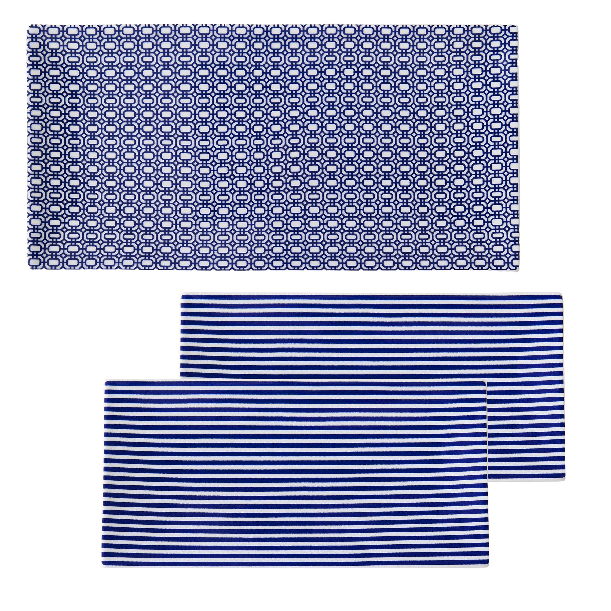 The Newport Serving Bundle by Caskata includes three mats: one with a blue and white geometric pattern and two featuring blue and white stripes. Ideal for serving appetizers on bone china trays, these mats add elegance and ensure easy cleanup.