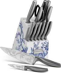 The Caskata X Cuisinart Limited Edition Arcadia 15-piece German Stainless Steel Cutlery Block, from Cuisinart, showcases knives with floral engravings on high carbon German stainless steel blades. The set includes several knives in a block adorned with a blue floral pattern, and two knives are displayed in front.