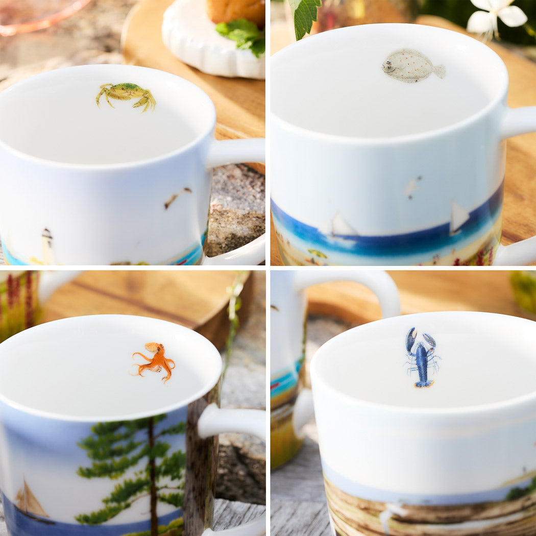 The Caskata X Felix Doolittle By the Sea Mugs, Set of 4, features a collage of porcelain mugs adorned with ocean-themed illustrations inside, including a crab, fish, octopus, and lobster. The exterior of each mug showcases a watercolor landscape depicting coastal scenes.