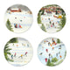 A set of four Caskata X Felix Doolittle Winter Wonderland Plates by Caskata, featuring watercolor landscapes of New England winter scenes with people sledding, skating, and a horse-drawn sleigh in snowy settings with trees, buildings, and mountains in the background.