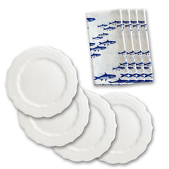 The Caskata High Tide Essentials Bundle includes four elegant white scalloped-edge dinner plates and five school of fish napkins, perfect for a beautifully coordinated display.