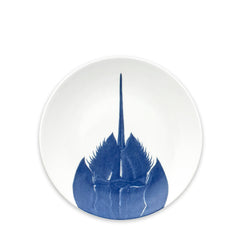 The Horseshoe Crab Coupe Salad Plate by Caskata Artisanal Home is a contemporary porcelain plate that elegantly showcases a blue illustration of a horseshoe crab.