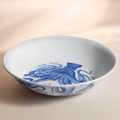 The Caskata Lucy Melamine Serving Bowl is BPA-free, featuring a striking blue octopus design inside and along the rim, ideal for outdoor dining.