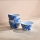 A set of four Lucy Melamine Snack Bowls by Caskata, featuring elegant blue octopus designs, are stacked gracefully on a light surface.