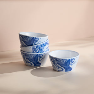 A set of four Caskata Lucy Melamine Snack Bowls, featuring white BPA-free melamine with blue octopus designs; three bowls are stacked, and one is separate on a light surface.