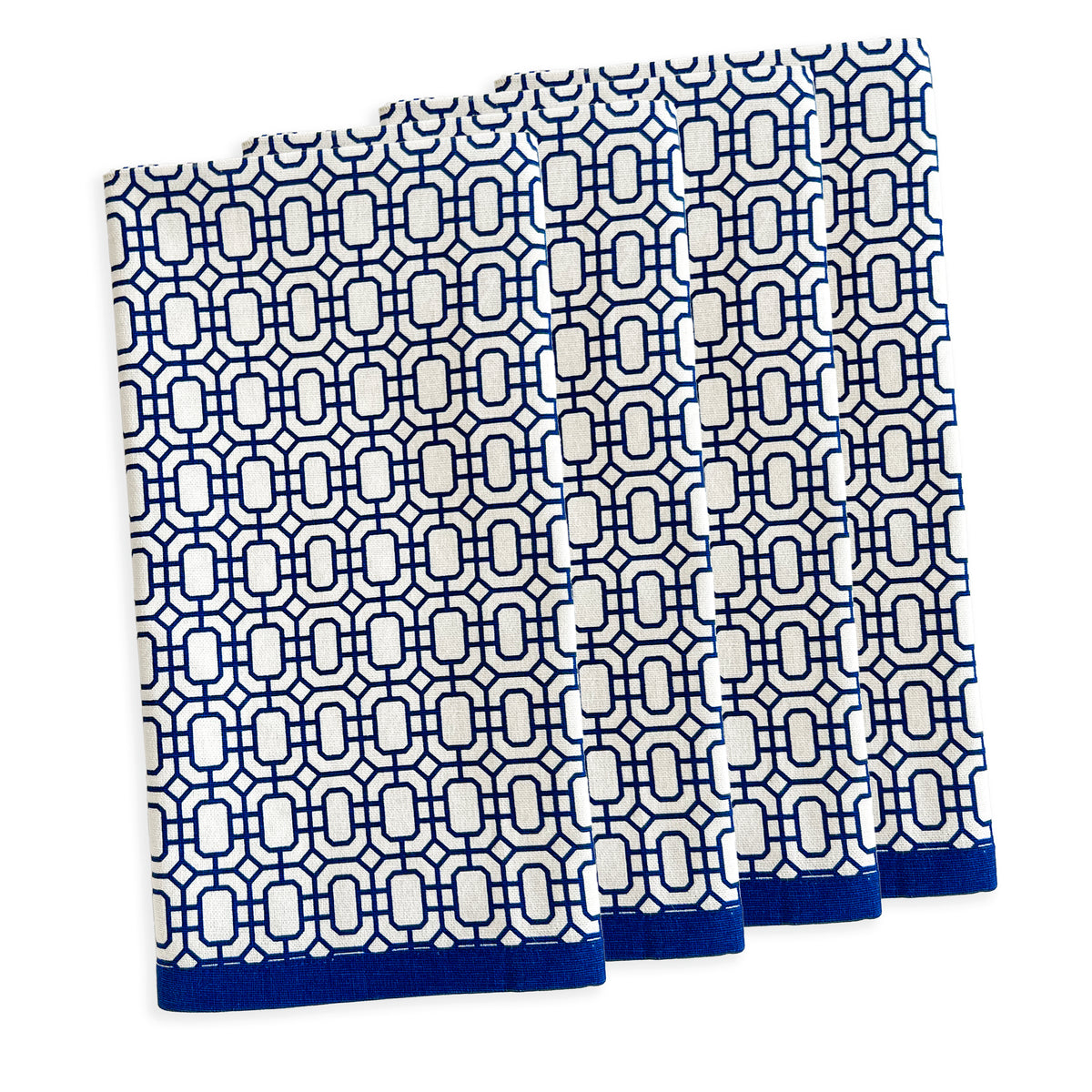 Four white and blue patterned towels, resembling the elegant style of Caskata&#39;s The After Tennis Dinner Bundle, are neatly stacked.