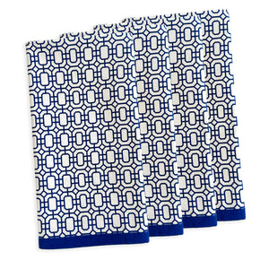 Four white and blue patterned towels, resembling the elegant style of Caskata's The After Tennis Dinner Bundle, are neatly stacked.