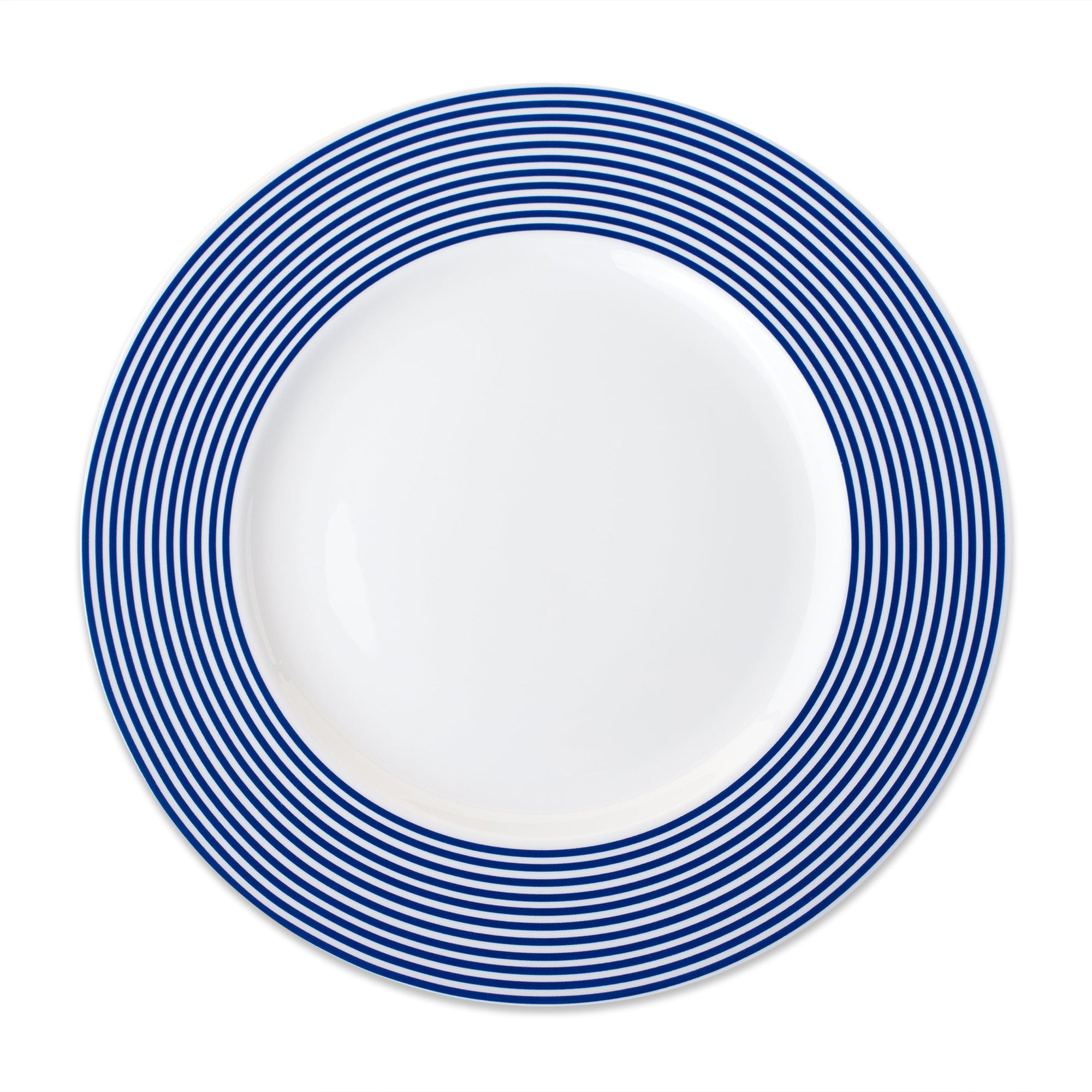 A white Newport Stripe Rimmed Dinner Plate by Caskata Artisanal Home with concentric blue circles around the edge, perfect for contemporary dinnerware collections.