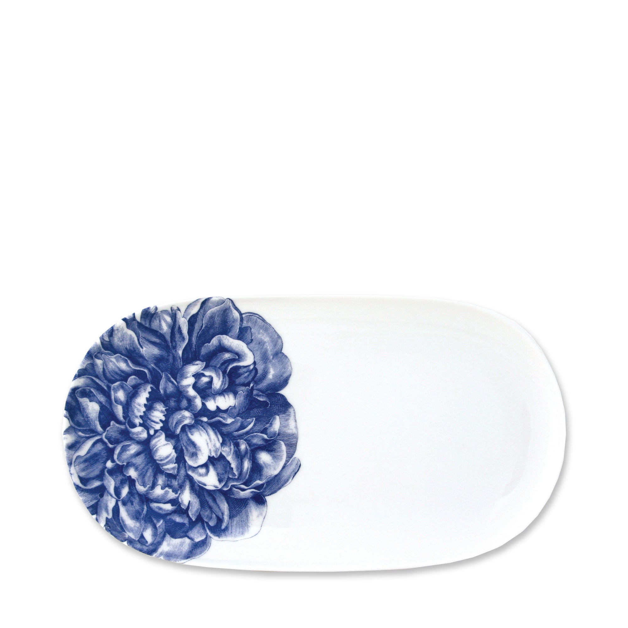 A Peony Small Oval Tray from Caskata Artisanal Home with a blue floral design on one end, perfect for adding a touch of elegance to your blue and white dinnerware collection.