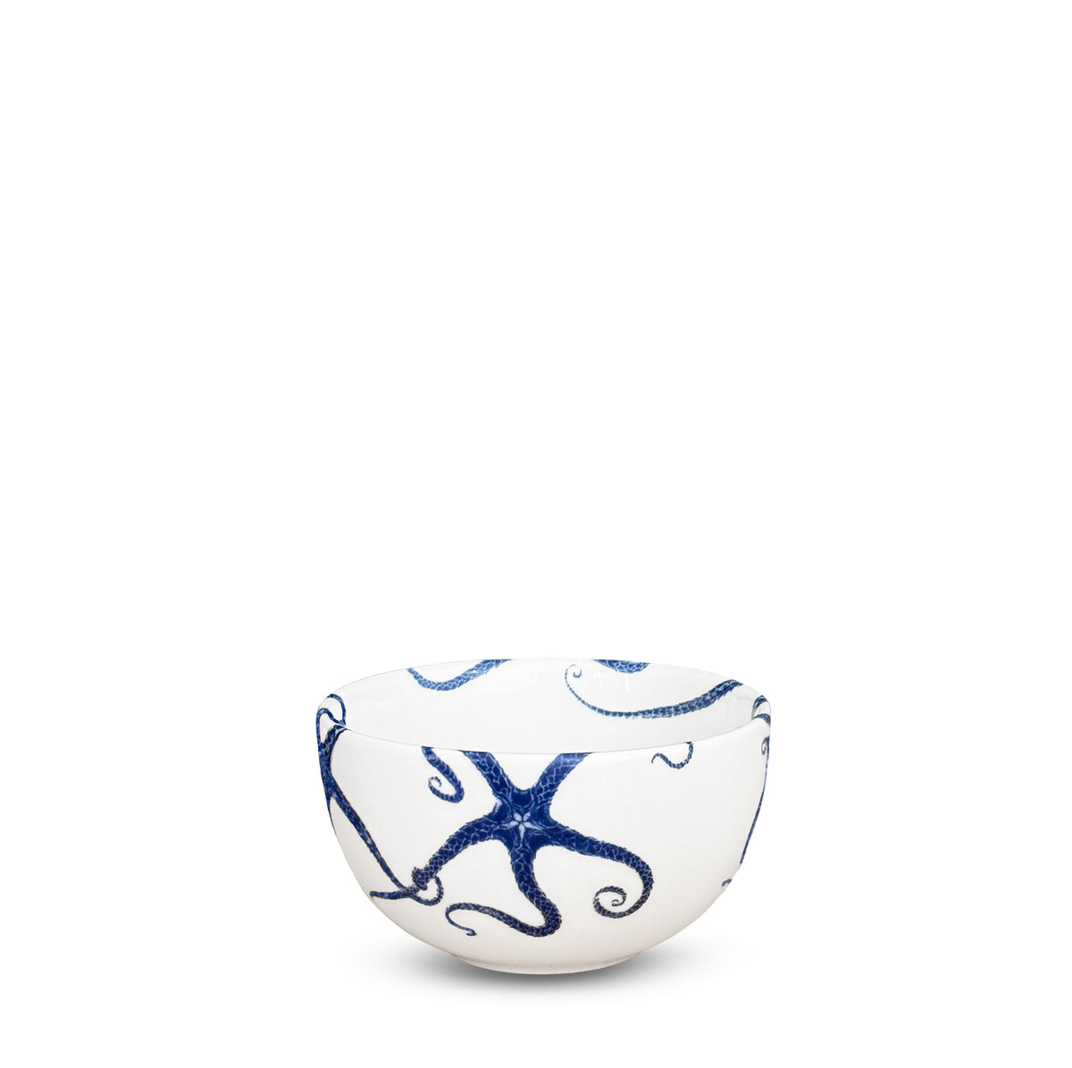 The Caskata Artisanal Home Starfish Snack Bowl, a small porcelain piece, is beautifully adorned with blue octopus designs that elegantly intertwine with intricate starfish motifs.