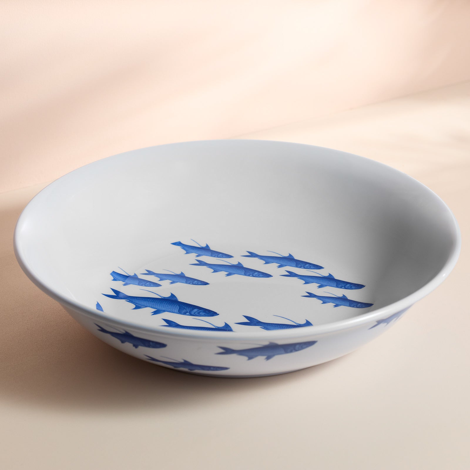 The Caskata School of Fish Melamine Serving Bowl features an elegant School of Fish pattern both inside and along the rim and is part of our BPA-free melamine collection.