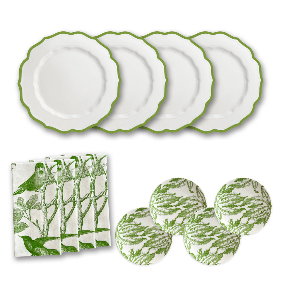 Introducing the Greenhouse Luncheon Bundle by Caskata: Ideal for simple gatherings, it features four white plates with green scalloped edges, four napkins with a charming bird pattern, and floral-design coasters—everything for a spring table refresh.