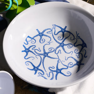 The Caskata Starfish Melamine Serving Bowl combines style and practicality, featuring a decorative pattern of blue octopuses on white, and is made from BPA-free melamine. Perfect for outdoor entertaining, it’s part of an unbreakable dinnerware collection.