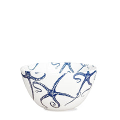 Introducing the Caskata Starfish Cereal Bowl, a white porcelain bowl featuring elegant blue octopus designs, perfect for enjoying your morning cereal.