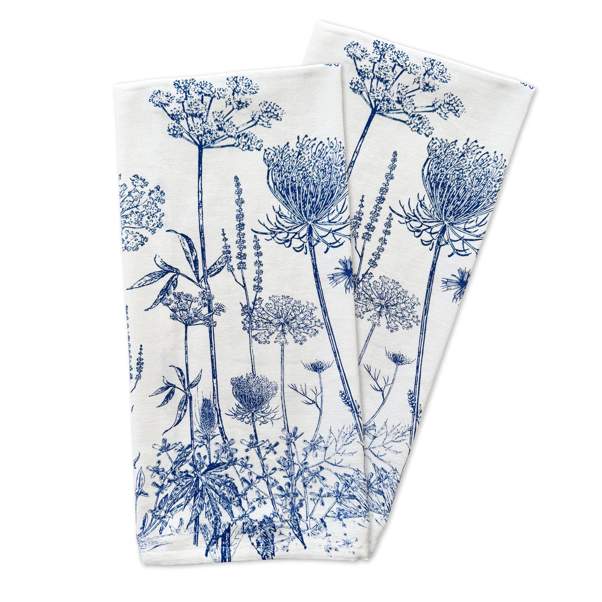 The set of two kitchen towels, named Summer Blues by Caskata, showcases a botanical pattern with blue illustrations of various flowers and plants.