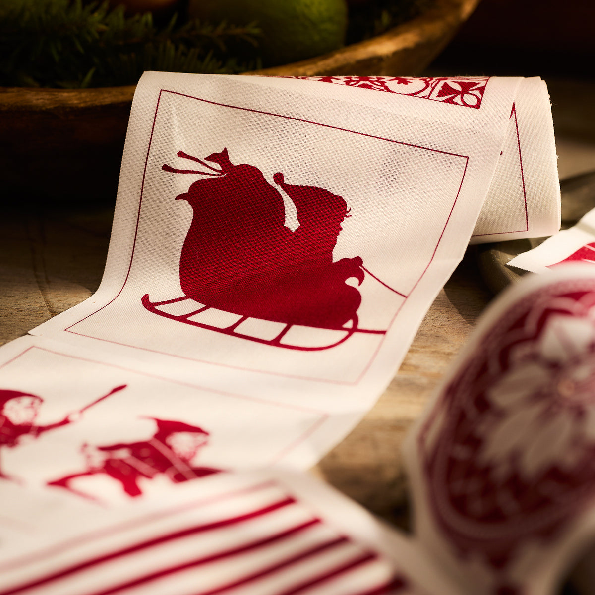 This set of Holiday Fun Cocktail Napkin Rolls by MY DRAP features a charming red silhouette of Santa&#39;s sleigh against a crisp white background, making it perfect for crafting festive, holiday-ready patterns. These rolls are ideal for creating reusable napkins that bring seasonal charm to any table setting.